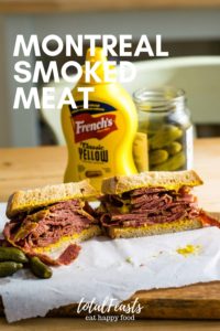 Montreal Smoked Meat sandwich on table with mustard and bread