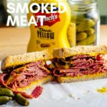 smoked meat sandwich on board with mustard and rye bread