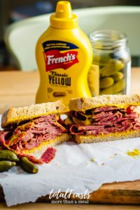 smoked meat sandwich on rye bread and mustard
